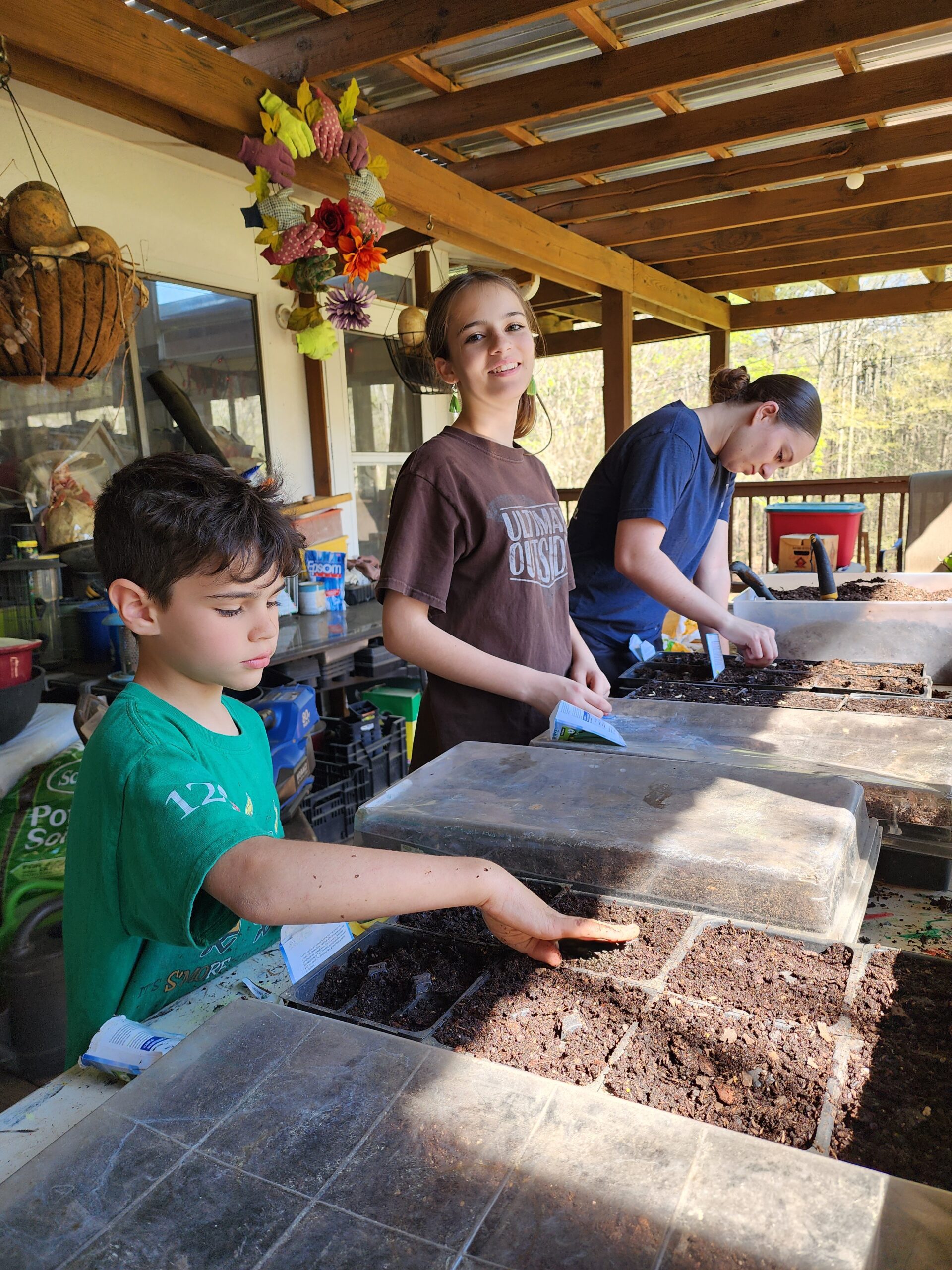 Kids helping out planting starters